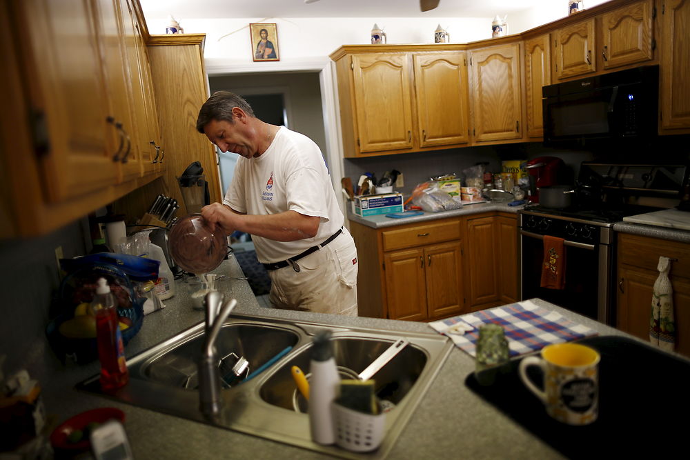 U.S. Republican presidential candidate Michael Petyo works in the kitchen while preparing baked goods to be sold to support his church in Portage, Indiana, November 12, 2015. Reuters Photographer Jim Young: "Hillary and Donald are running. So are more than 1, 500 others, among them Michael Petyo of Hobart, Indiana. He's not a household name, nor does he have millions of dollars in backing. Petyo is a building contractor, a father and a U.S. Navy veteran. Back in May, Petyo handed me his card. He was outside an event in Des Moines, Iowa, attended by leading potential Republican candidates. Petyo said the party wouldn't let him inside. We only spoke for a minute. Months later, I read of a few hundred people having already signed up to run for president: businesspeople, teachers, bartenders. Petyo lives about 75 miles from me so I arranged to meet. We spoke for a couple of hours at his dinner table with his wife. This is my fourth presidential election campaign. I have logged countless miles and been to hundreds of events - but always with candidates with massive financial backing and support from countless volunteers. Petyo has business cards, his van, his beliefs. He speaks about the working class, faith, the military. In his spare time he bakes to raise money for the church. Religion is important to him and he speaks about it passionately. Over the months we meet up while he campaigns and goes about his life. Petyo drives to a Republican debate in Milwaukee in November; the door is shut there too. He still works the lines of attendees outside. In Chicago people brush by on a cold, windy day as he tries to introduce himself. Some stop to ask him about his policies. He is not a full-time politician, just a regular guy facing what many would call insurmountable obstacles. It's quite the understatement to say the odds are stacked against him. But that shouldn't stop him or anyone from trying." REUTERS/Jim Young SEARCH "PETYO" FOR ALL IMAGES